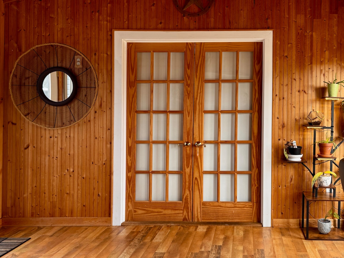 Wood-paneled entry with French doors
